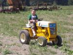 Nicholas on his 1965 Cub Cadet 102.  At least he's wearing a John Deere t-shirt.